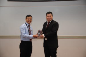 A group of people at Republic Polytechnic's 2018 event, smiling and holding awards for partnership excellence.