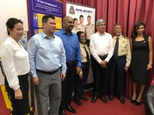 A minister discussing security measures with officials during a visit to a security agency.